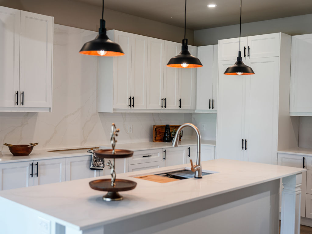 Finished classic-style Charlotte kitchen renovation featuring custom shaker cabinetry and a quartz island