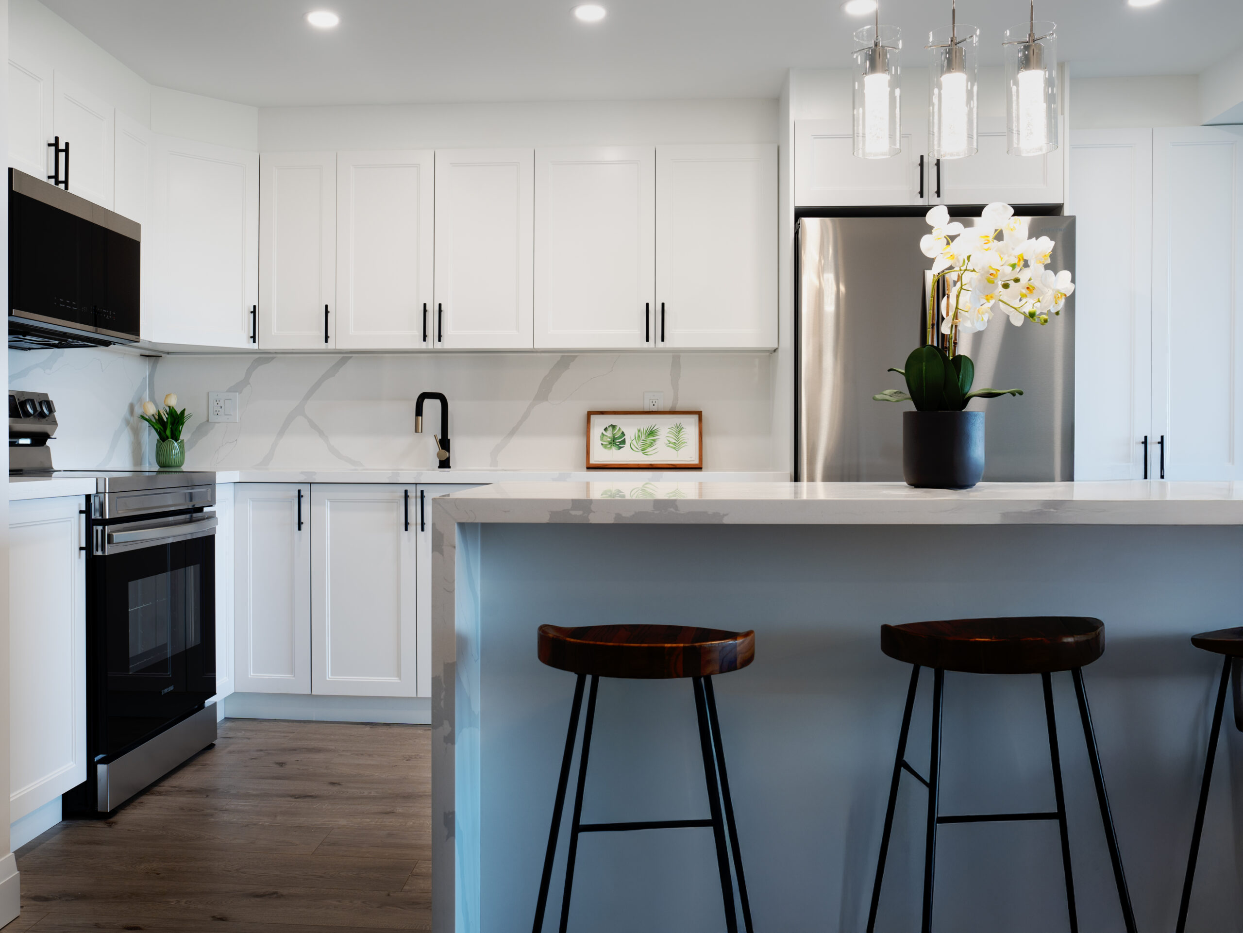 Luxury signature custom kitchen renovation with European cabinetry and a premium quartz waterfall island